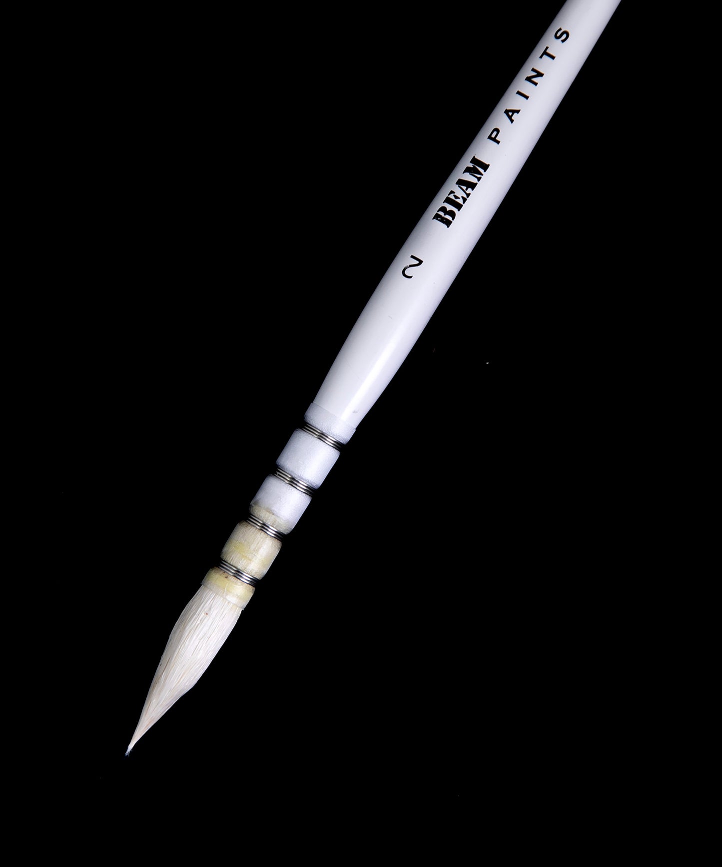 close up of natural wool mop brush against black background