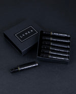 Black cardboard box containing all 7 LVNEA Eau de Parfum sample vials