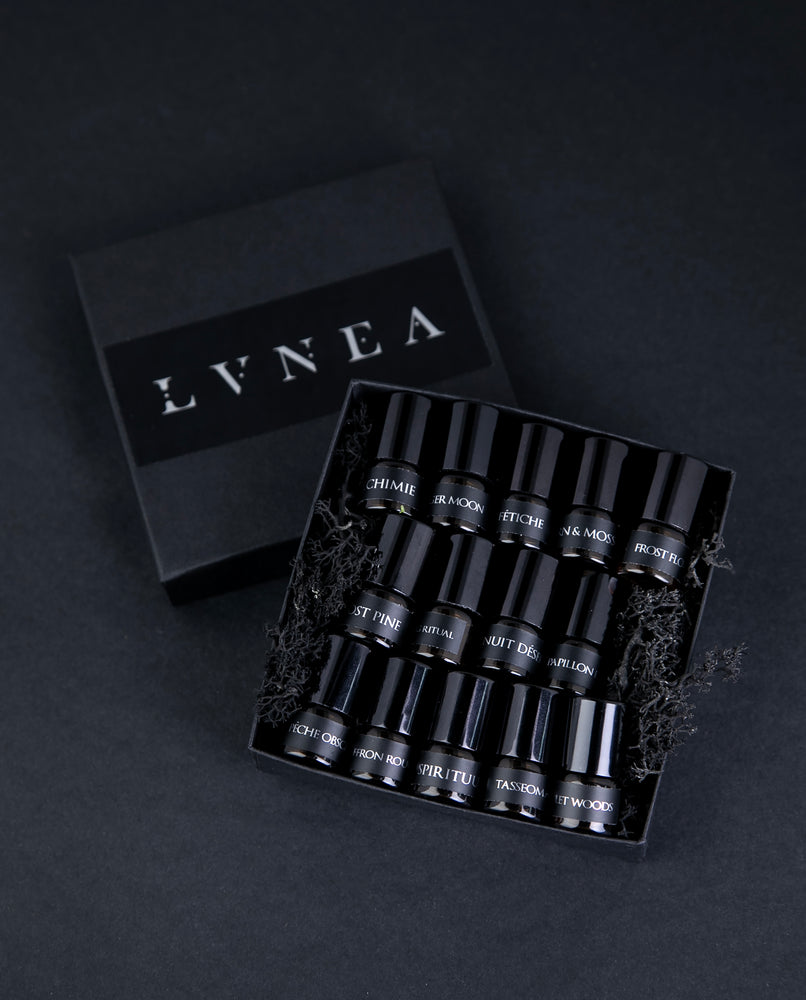 Sample set of all 14 LVNEA oil perfumes in a moss-filled black box. Sample bottles are 1.25 ml glass vials.