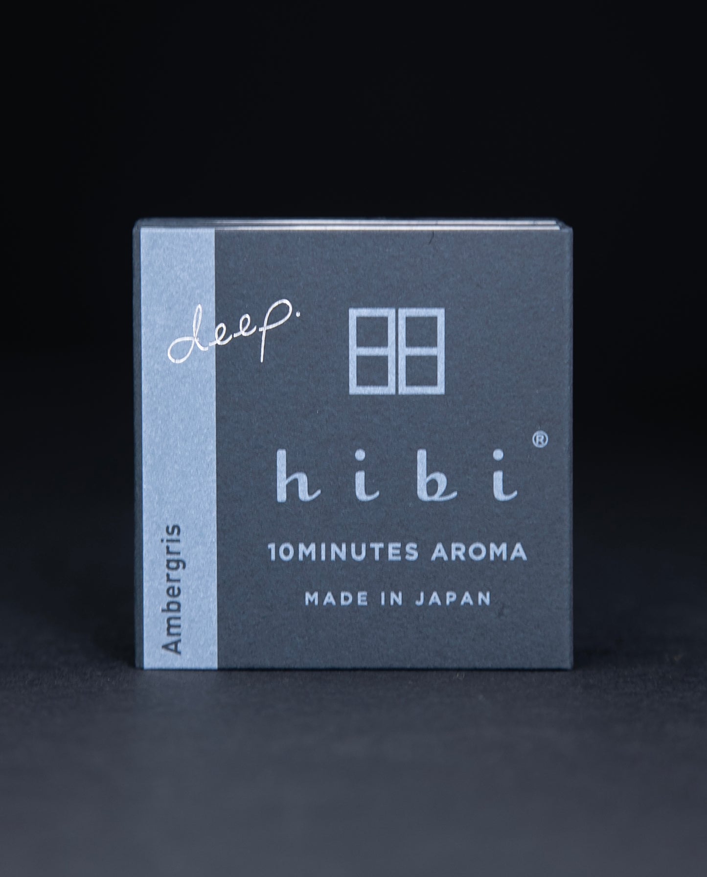 dark slate grey paper box containing HIBI