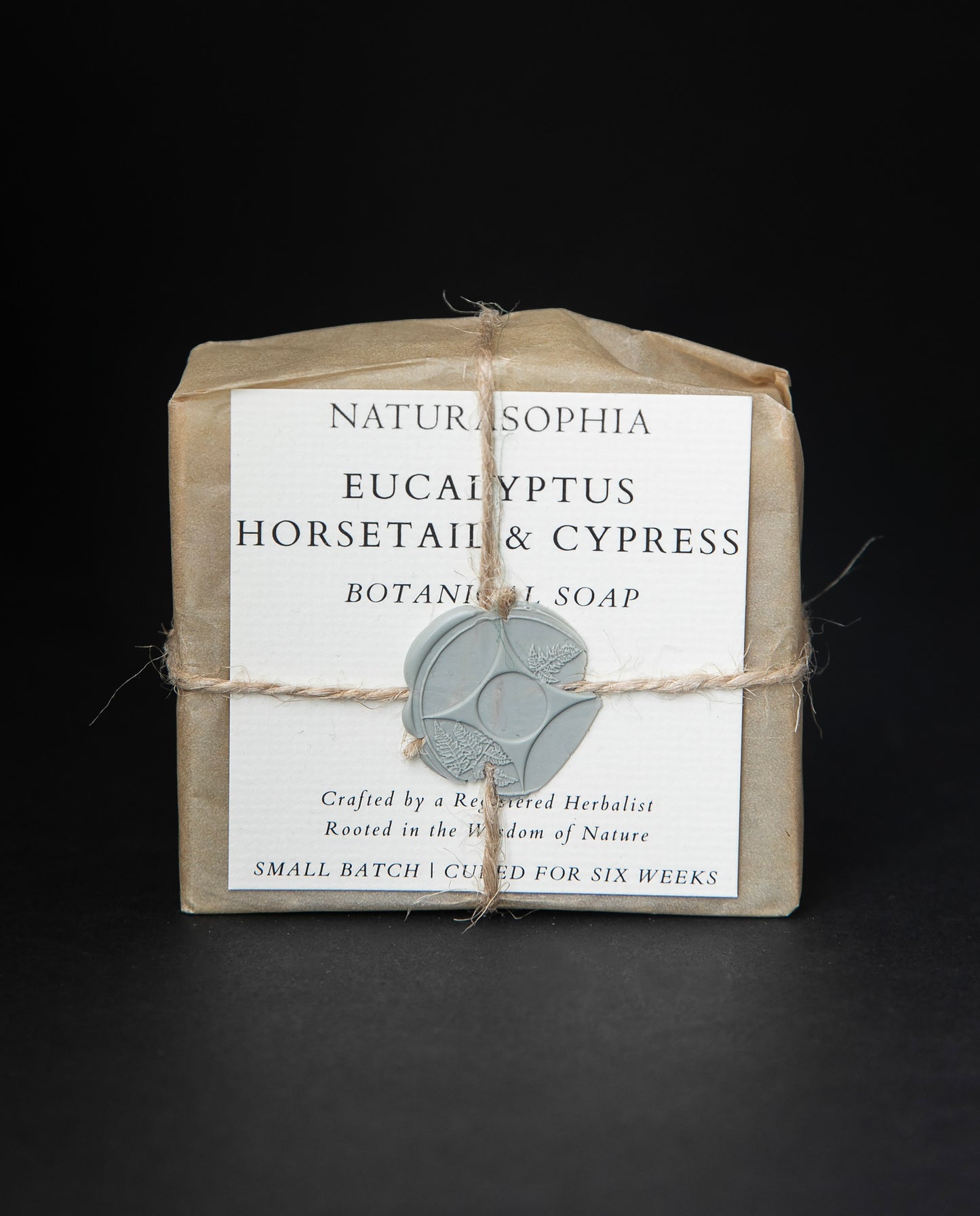 Bar of Naturasophia soap wrapped in brown paper and twine, with a label that reads