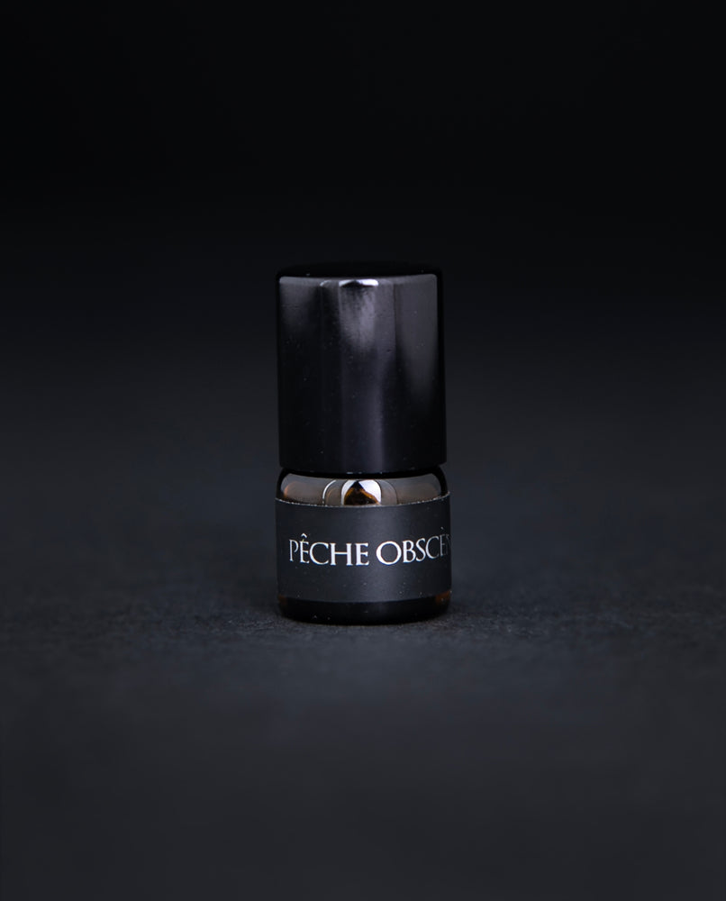 Single amber glass 1.25ml parfum botanique sample on black background