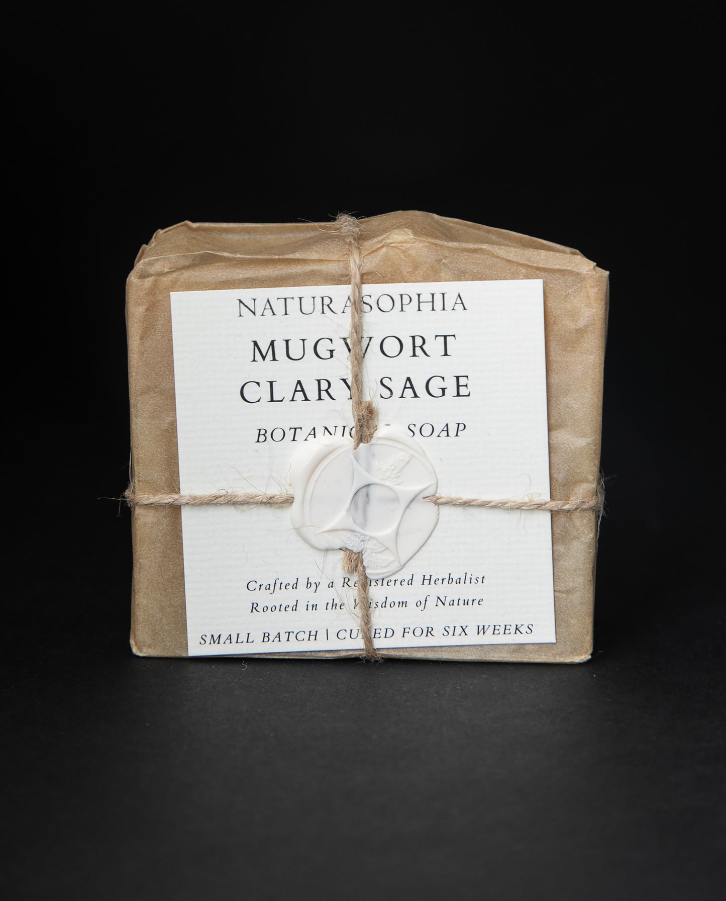 Bar of Naturasophia soap wrapped in brown paper and twine, with a label that reads