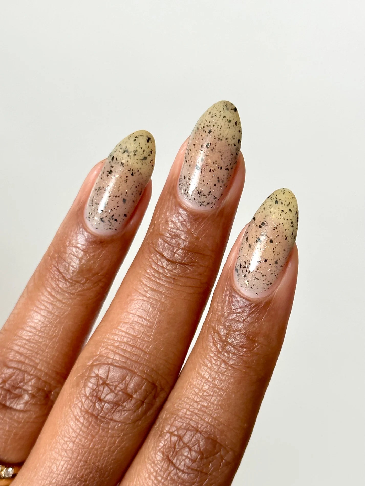 Close up of nails with grey speckled polish