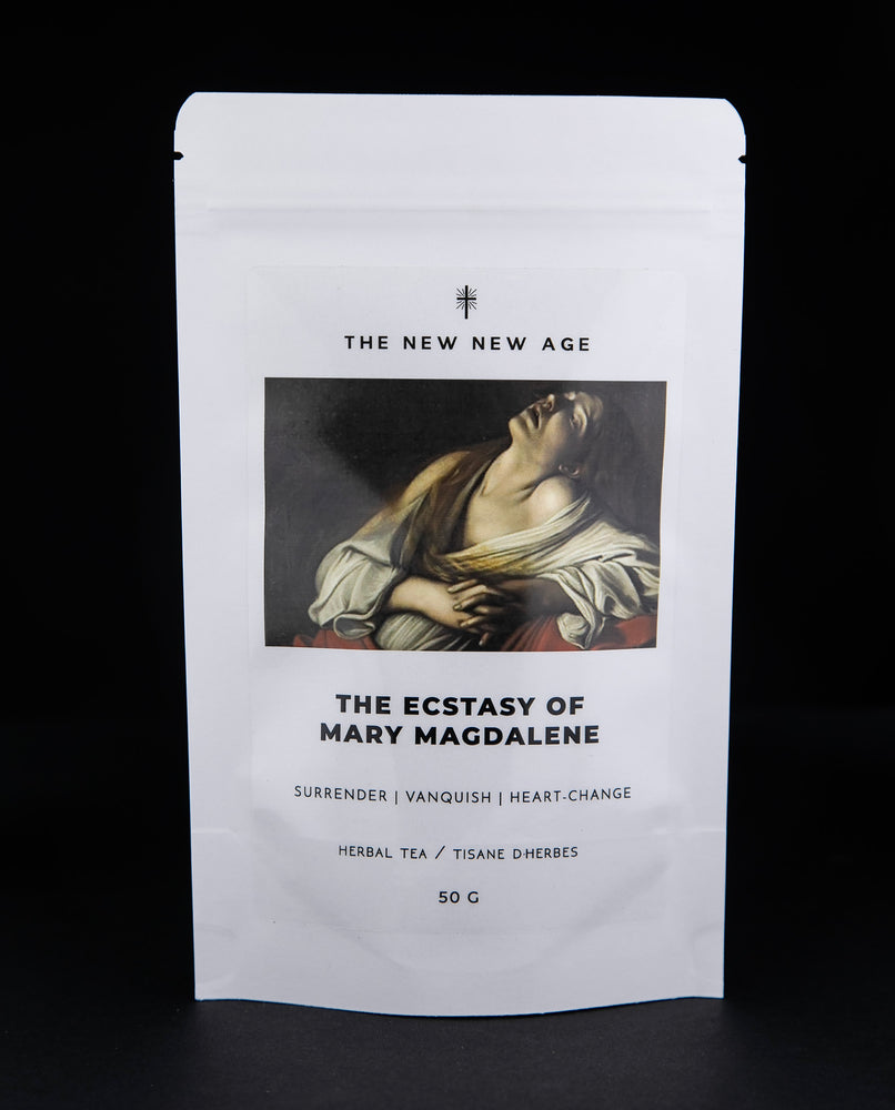 White 50g pouch of "The Ecstasy of Mary Magdalene" herbal tea against black background. There is an illustration of Mary Magdalene on the front.