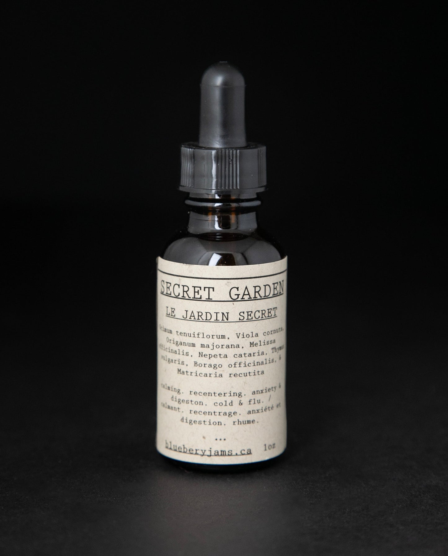 Black glass bottle with dropper top of blueberryjams'