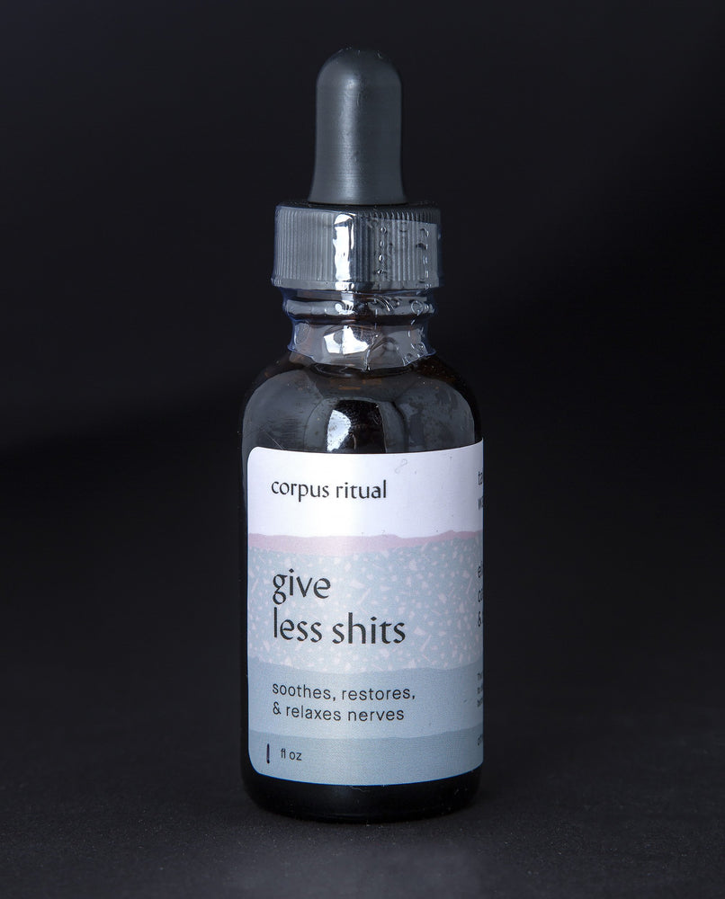 black glass bottle with black dropper top. The bottle contains corpus ritual's "give less shits" herbal tincture