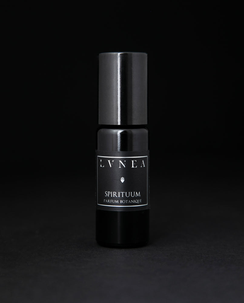 10ml black glass bottle of LVNEA's Spirituum natural roll on perfume oil on black background