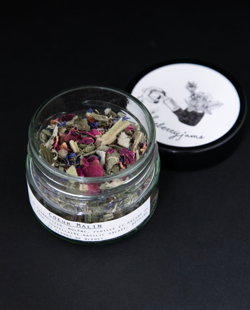 Open jar of Blueberryjams "Wicked Hearts" rolling blend, revealing a ciolourful herbal blend.
