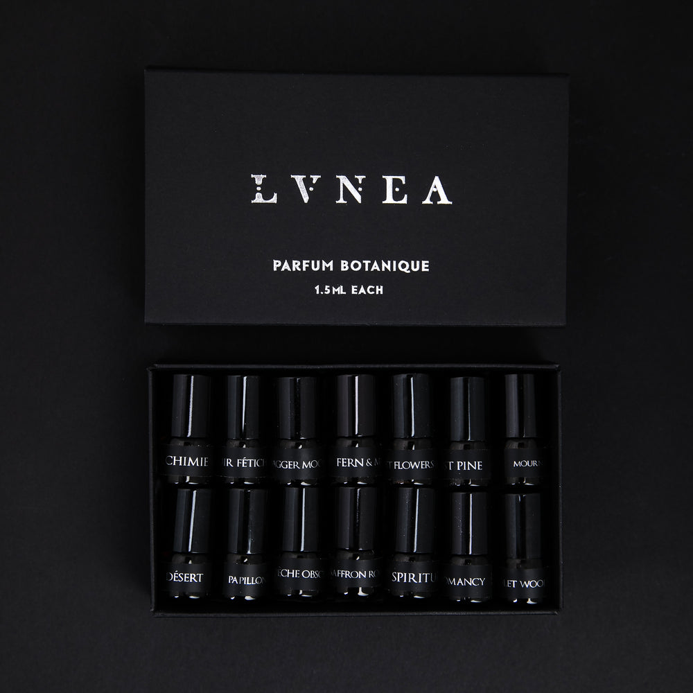 
                      
                        set of 14 1.25ml parfum botanique sample vials nestled together in a black box with the lid open
                      
                    