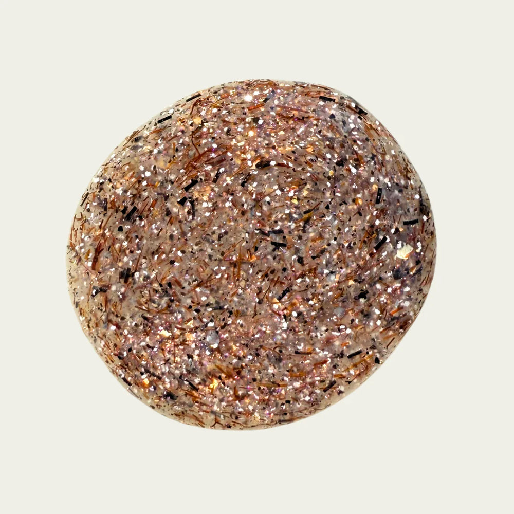 swatch of brown, white, and glittery nailpolish on white background