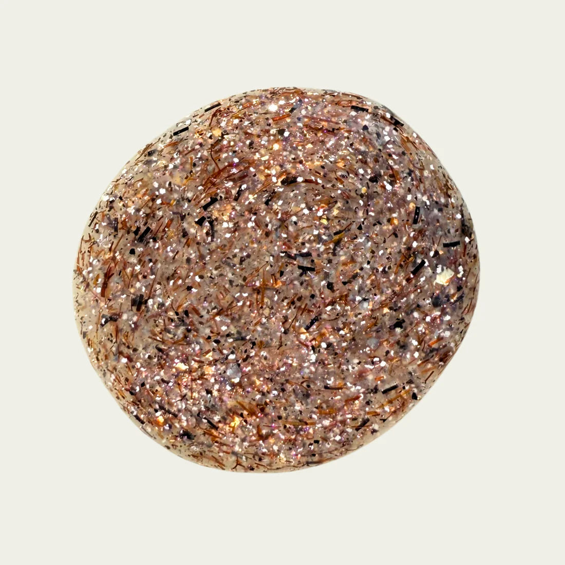 swatch of brown, white, and glittery nailpolish on white background