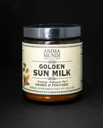 Amber glass jar with black lid and tan label. The jar contains Anima Mundi's "Golden Sun Milk" herbal supplement.