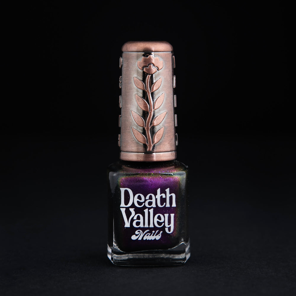 "Bat out of Hell" nail polish on black background. The polish is a multichrome purple colour.