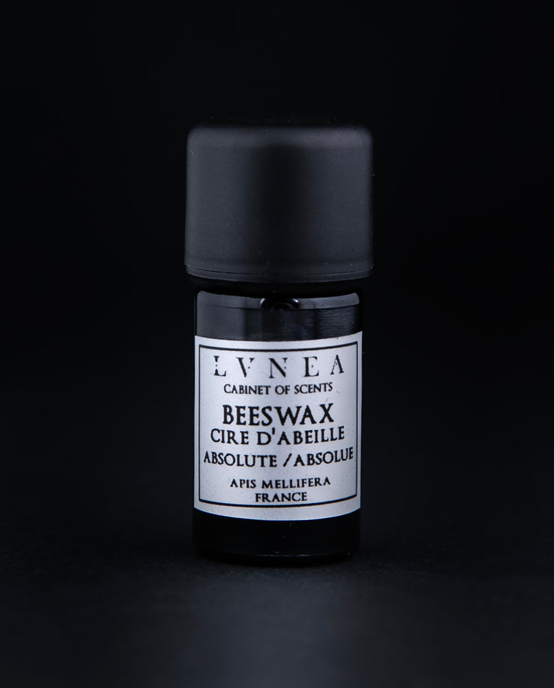 5ml black glass bottle of beeswax absolute on black background