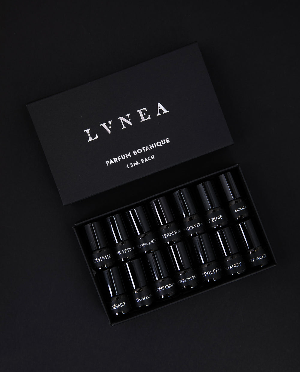 black paper box containing LVNEA's full 14-piece parfum botanique sample set