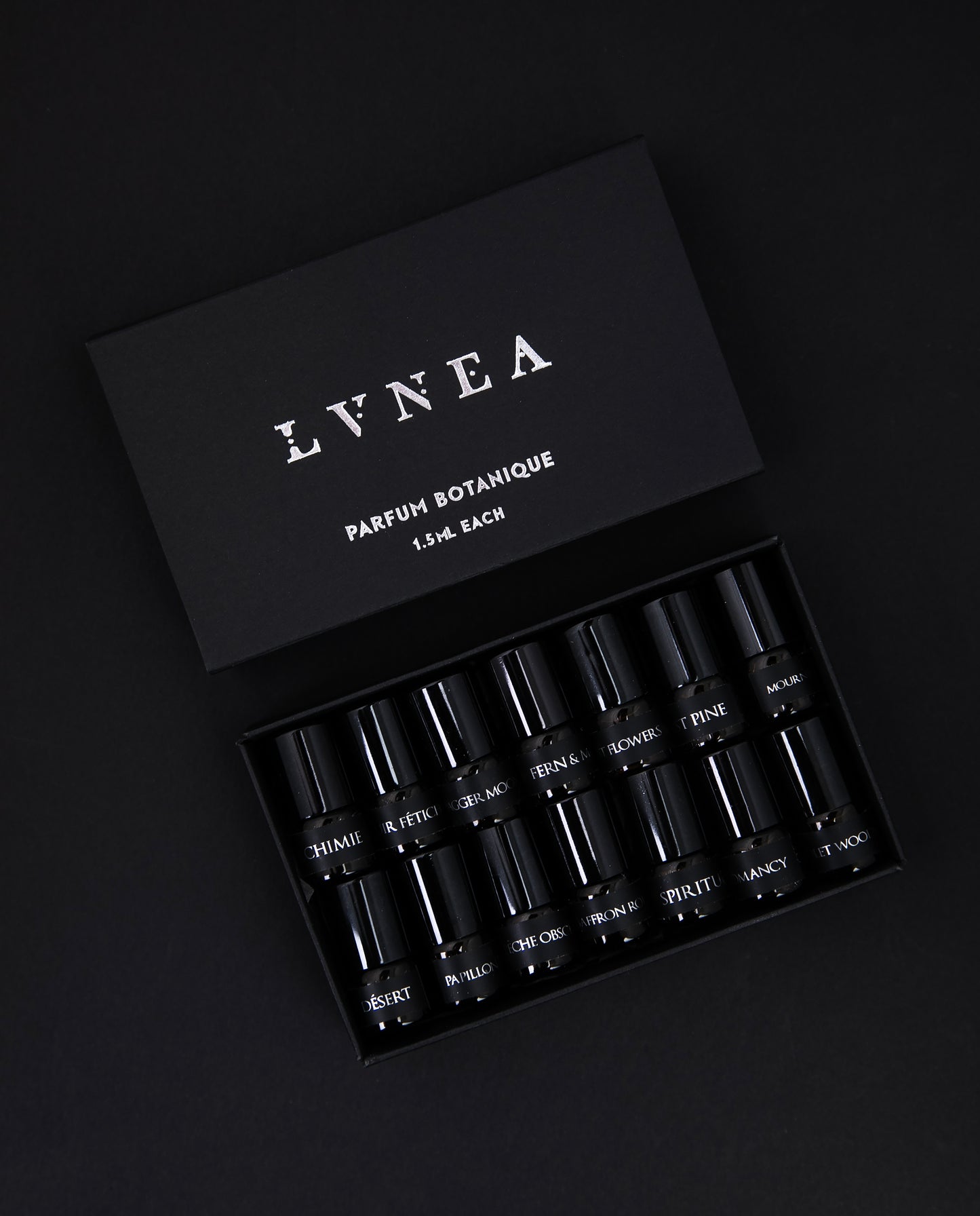 black paper box containing LVNEA's full 14-piece parfum botanique sample set