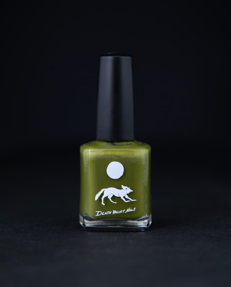 "Crocodilia" nail polish by Death Valley Nails on black background. The polish is a muted earthy chartreuse green colour.