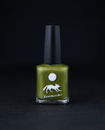 "Crocodilia" nail polish by Death Valley Nails on black background. The polish is a muted earthy chartreuse green colour.