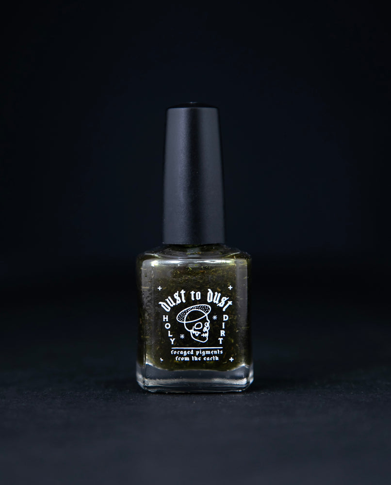 "Dill Weed" nail polish from death valley nails on black background. The polish features bits of real dillweed and is tinted transparent green.
