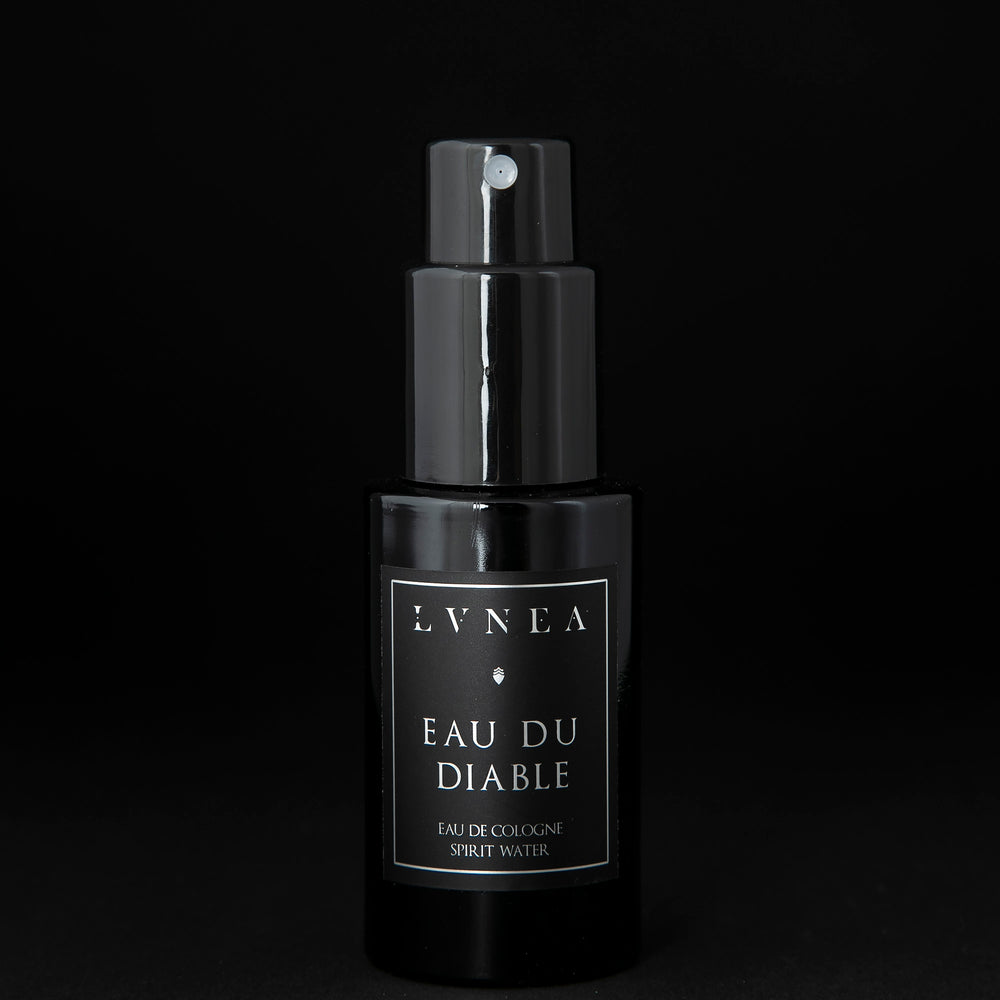 50ml black glass bottle of LVNEA’s Eau du Diable natural fragrance on black background