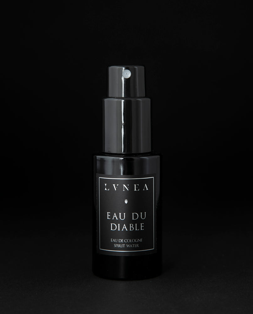 50ml black glass bottle of LVNEA’s Eau du Diable natural fragrance on black background