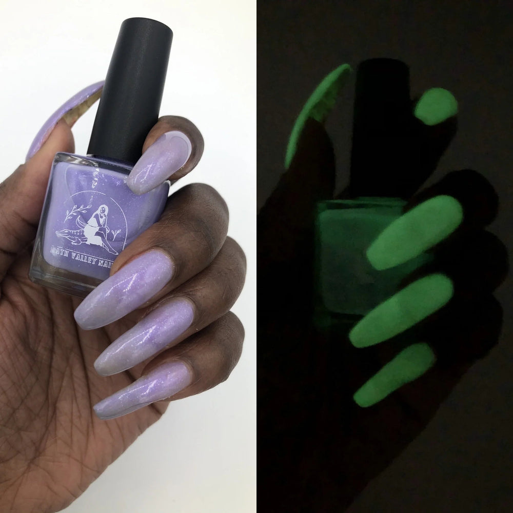 Close up of nails painted with Death Valley Nails' "Gris-gris of the Bog" nail polish. On the left the polish is seen in natural light, on the right the polish is seen glowing in the dark.