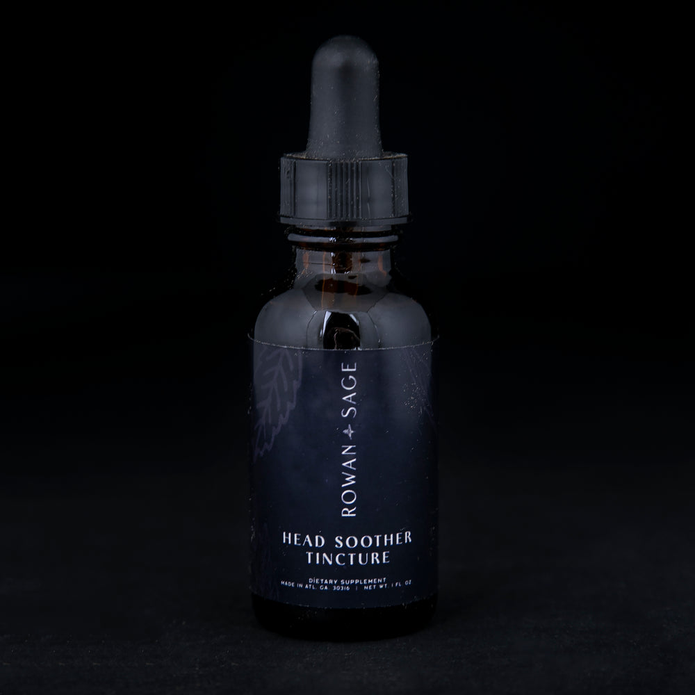 1oz amber glass bottle with dropper top and black label, containing Rown + Sage's "Head Soother" tincture on black background.