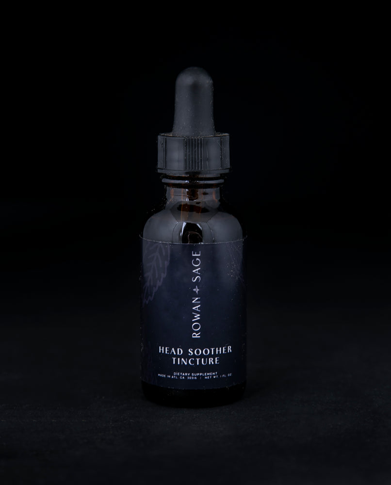 1oz amber glass bottle with dropper top and black label, containing Rown + Sage's "Head Soother" tincture on black background.