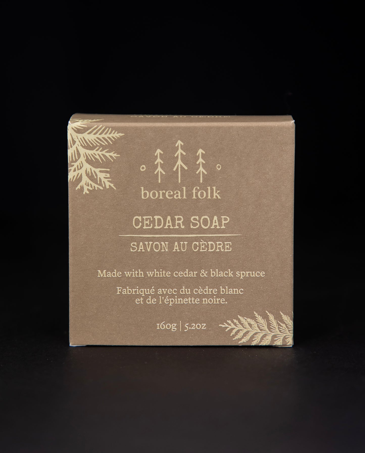 Light brown cardboard box of Boreal Folk's cedar soap against a black background