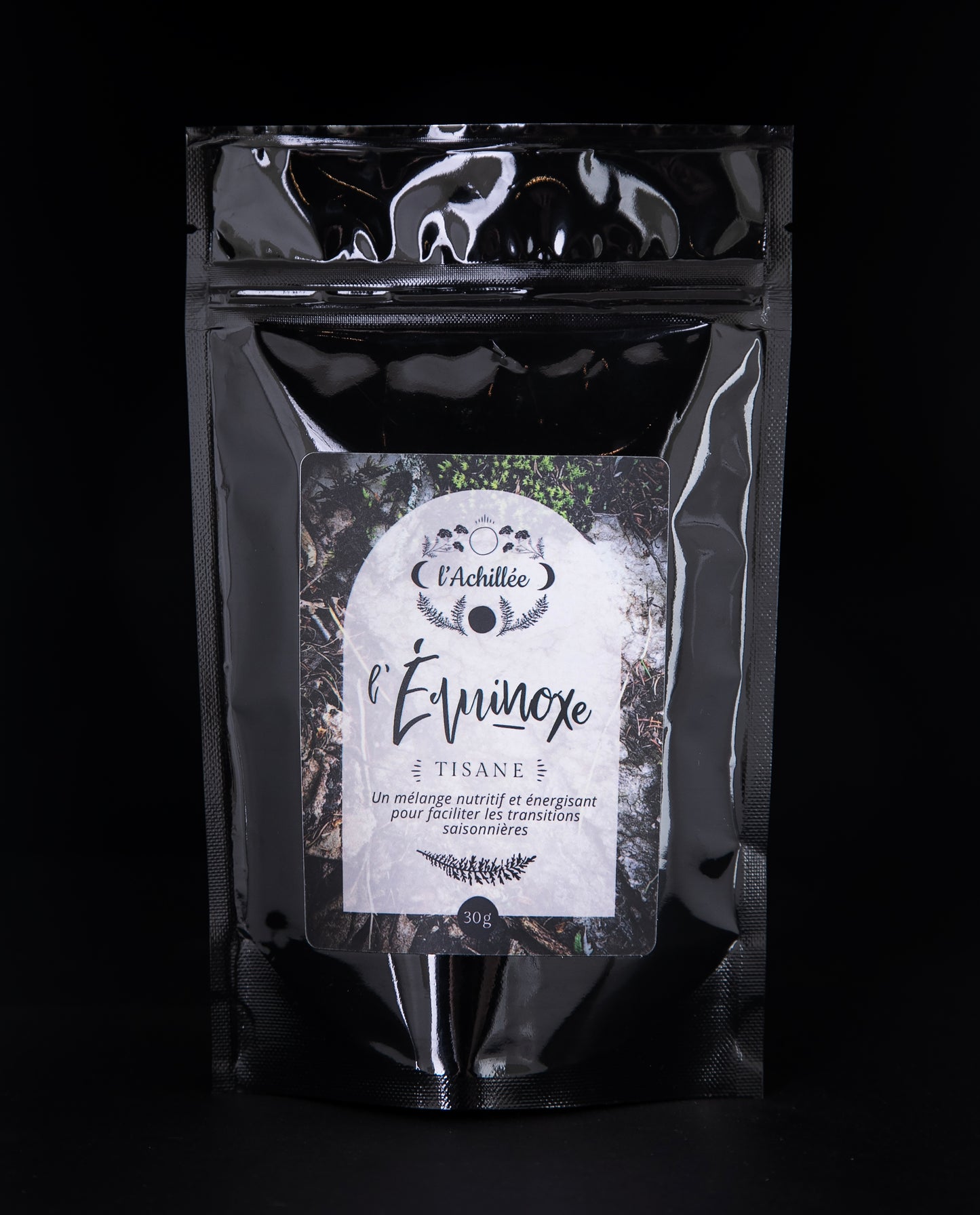 30g black bag of l'Achillée's "l'Équinoxe" loose leaf tea on a black background