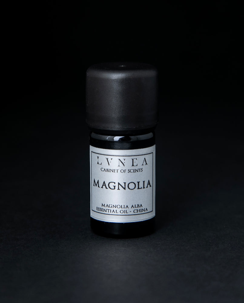 5ml black glass bottle of LVNEA's magnolia essential oil on black background. The label on the bottle is silver.