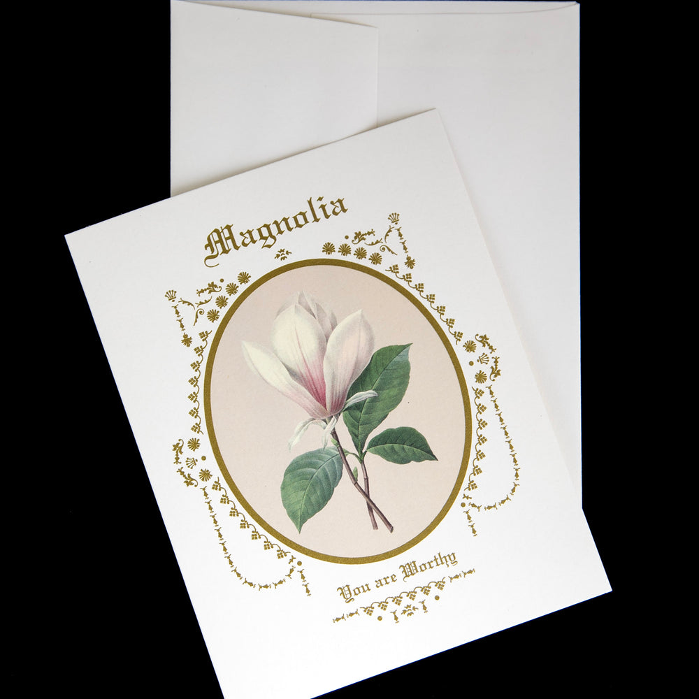magnolia greeting card sitting on its envelope against a black background