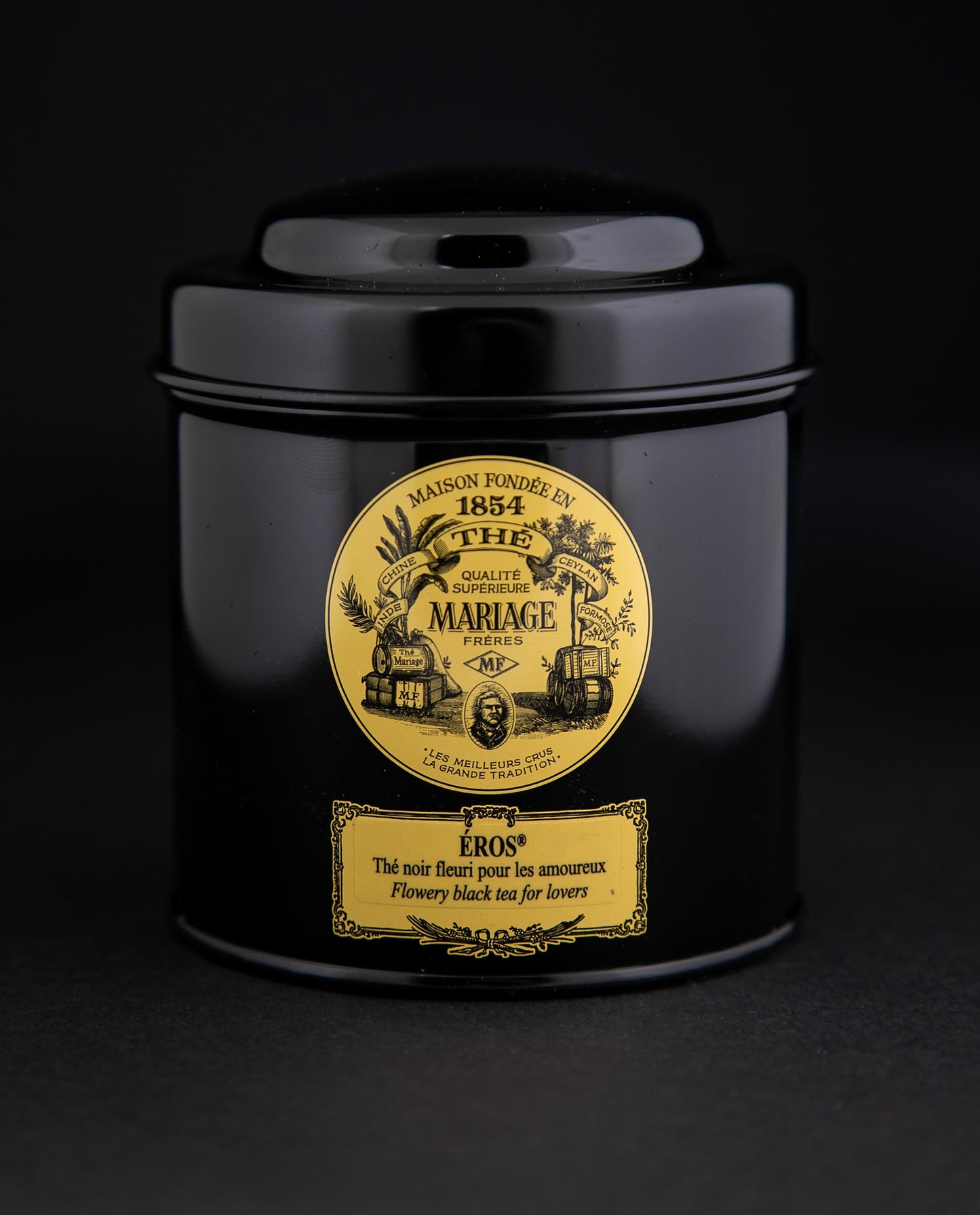 100g black laquered metal canister of Mariage Frère's "Eros" tea blend on black background.