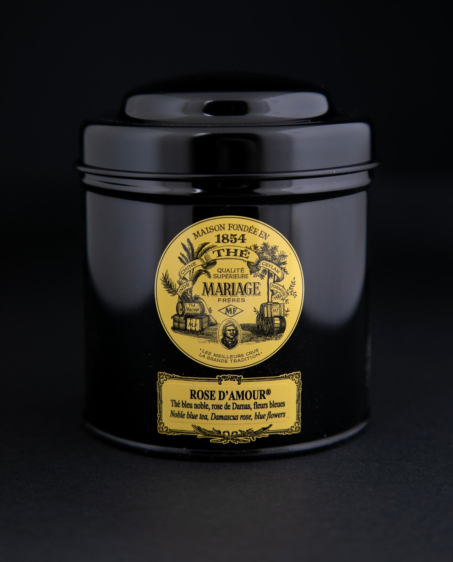 100g black laquered metal canister of Mariage Frère's "Rose D'amour" tea blend on black background.