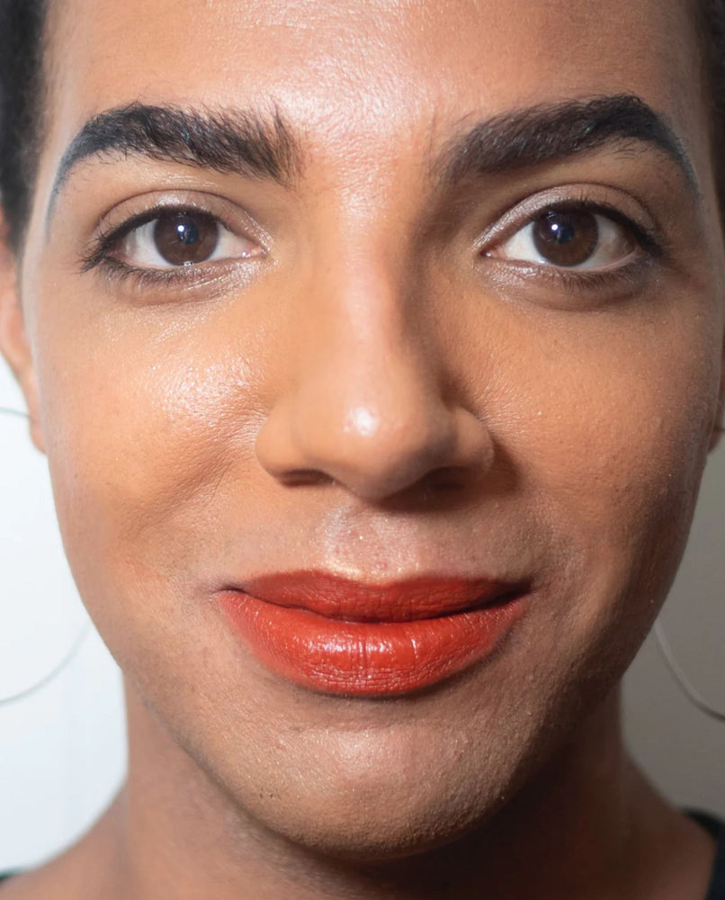 "Mortar and Pestle" brick red lip paint shown on model