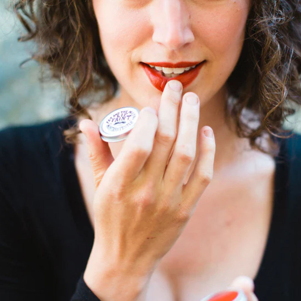 
                      
                        A model holds a pot of Fat and the Moon's "Mortar and Pestle" lip paint
                      
                    