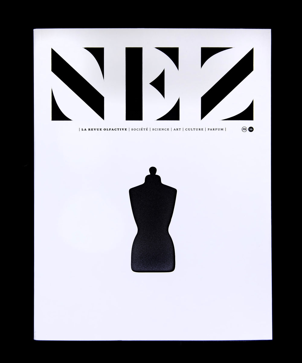 magazine with white cover and black cutouts reading 