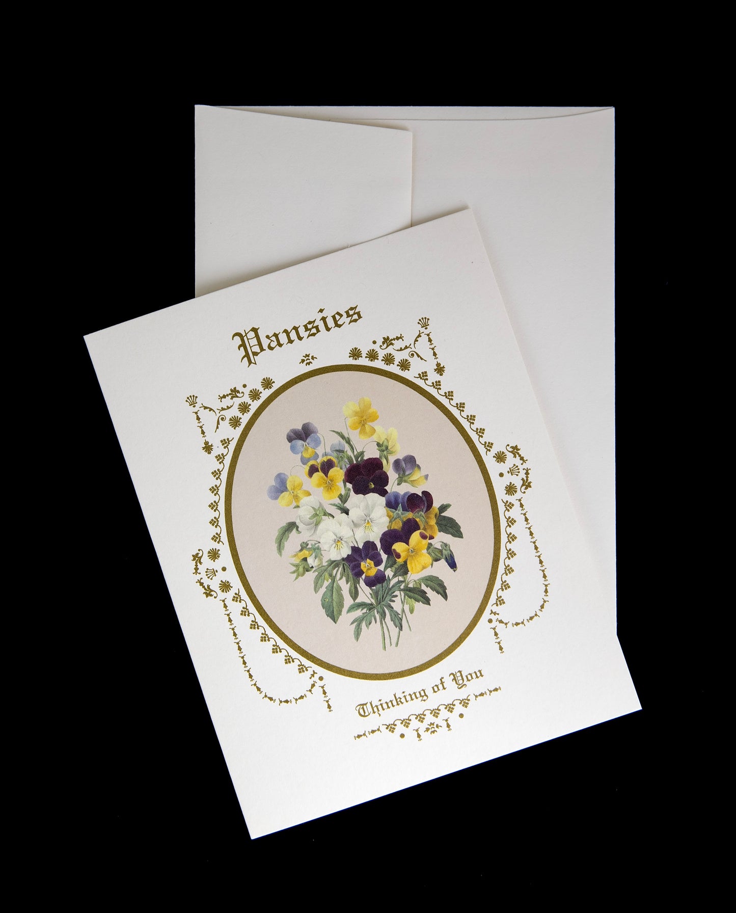 pansies greeting card sitting against its envelope on a black background