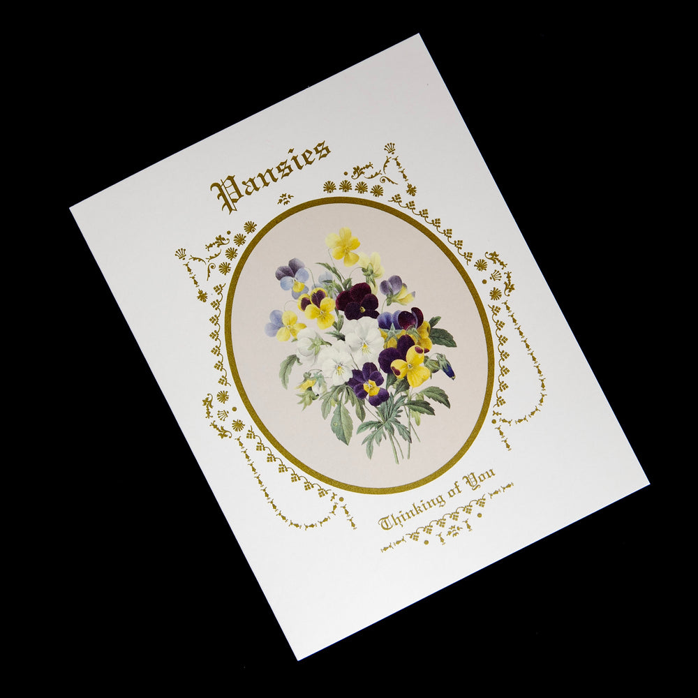 white greeing card featuring an illustration of pansies surrounded by a gilded frame