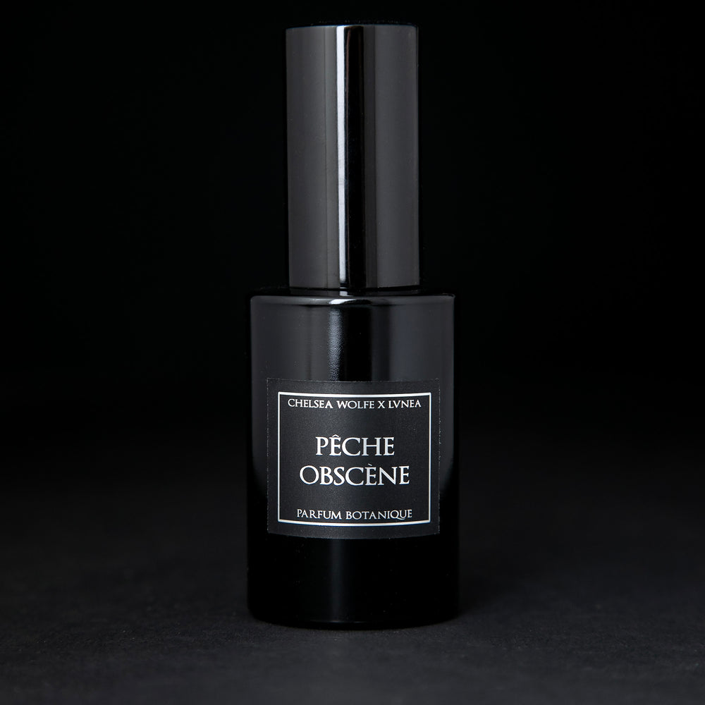 30ml black glass bottle of LVNEA's natural perfume Pêche Obscene on black background