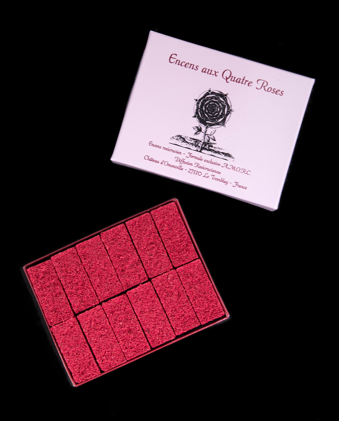 Open box revealing 12 tighly packed bricks of "Quatre Roses" incense
