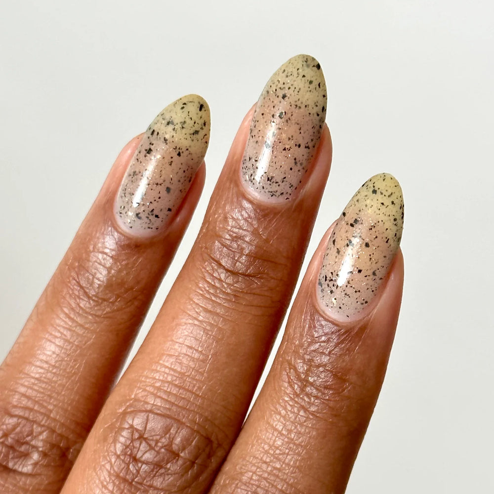 
                      
                        Close up of nails with grey speckled polish

                      
                    