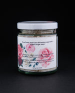 Back label of 130g clear glass jar of The New New Age's "Rose Flower Essences in Sugar". There are illustrations of roses on the label.