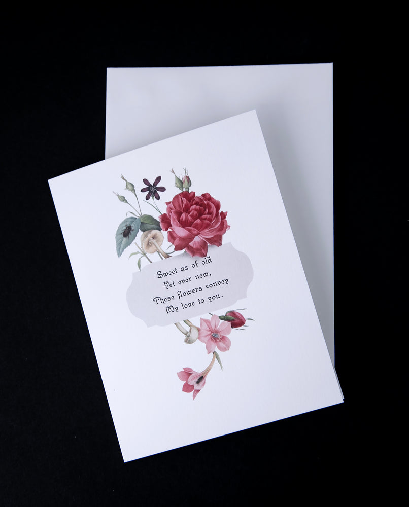 Greeting card sitting atop white enveloppe on black background