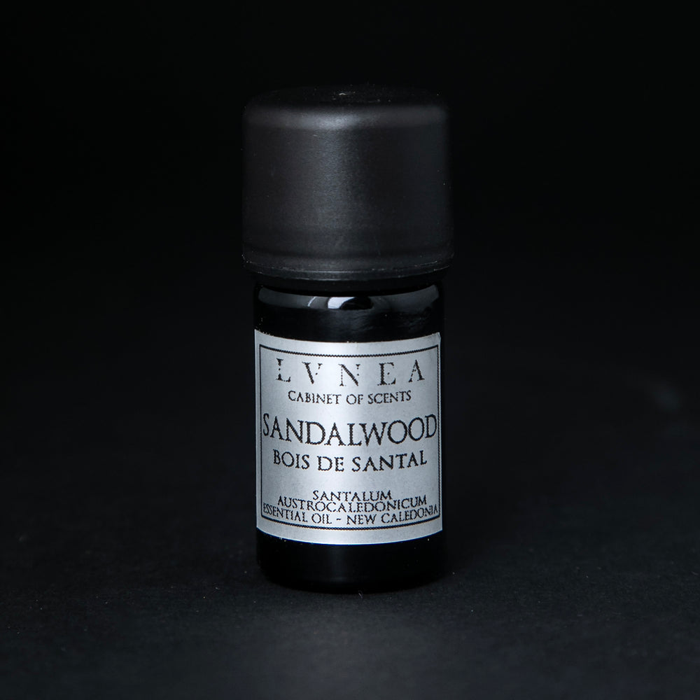 
                      
                        5ml black glass botttle of LVNEA's sandalwood essential oil on black background. The label on the bottle is silver.
                      
                    