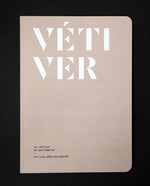 The book "Le vétiver en parfumerie" on black background. The cover is light brown and reads "VÉTIVER" in bold white graphic lettering.