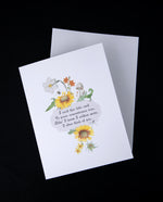 Greeting card on top of white enveloppe on black background