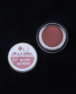 open glass pot of Fat and the Moon "Wood Nymph" lip paint, revealing a dusty rose lip colour