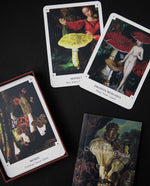 An assortment of cards from the Mushroom Oracle Deck scattered across a black background